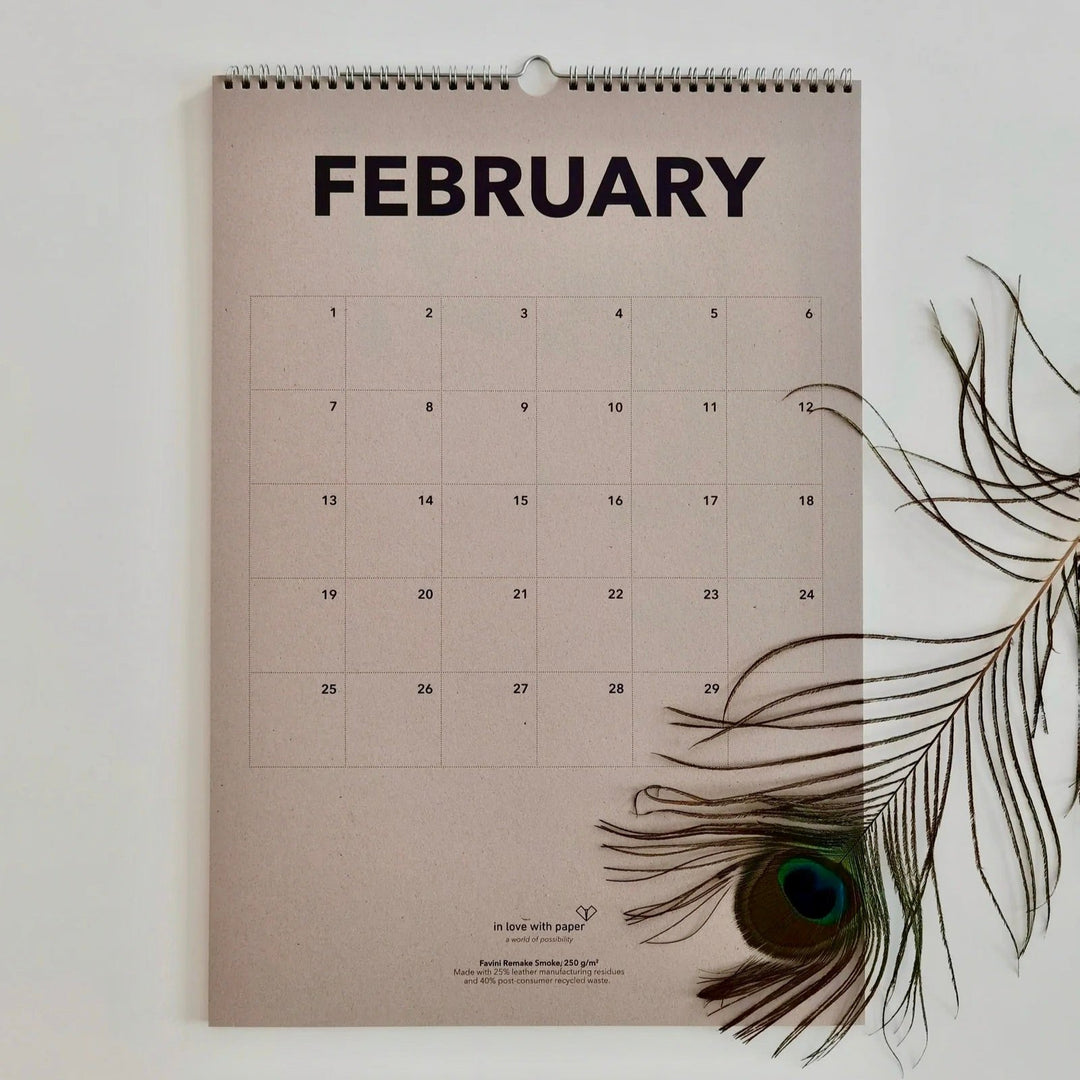 Beige page showing the everlasting calendar in the month February with peacock feather