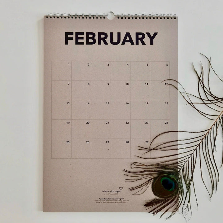 Beige page showing the everlasting calendar in the month February with peacock feather