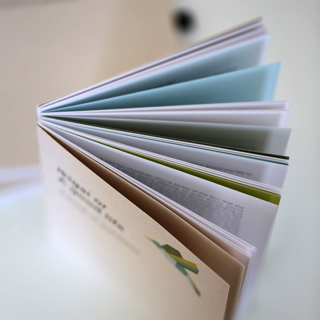 Open 'Ikigai or A Good Life' book displaying colorful pages, showcasing its eco-friendly design and thoughtful layout for self-reflection.