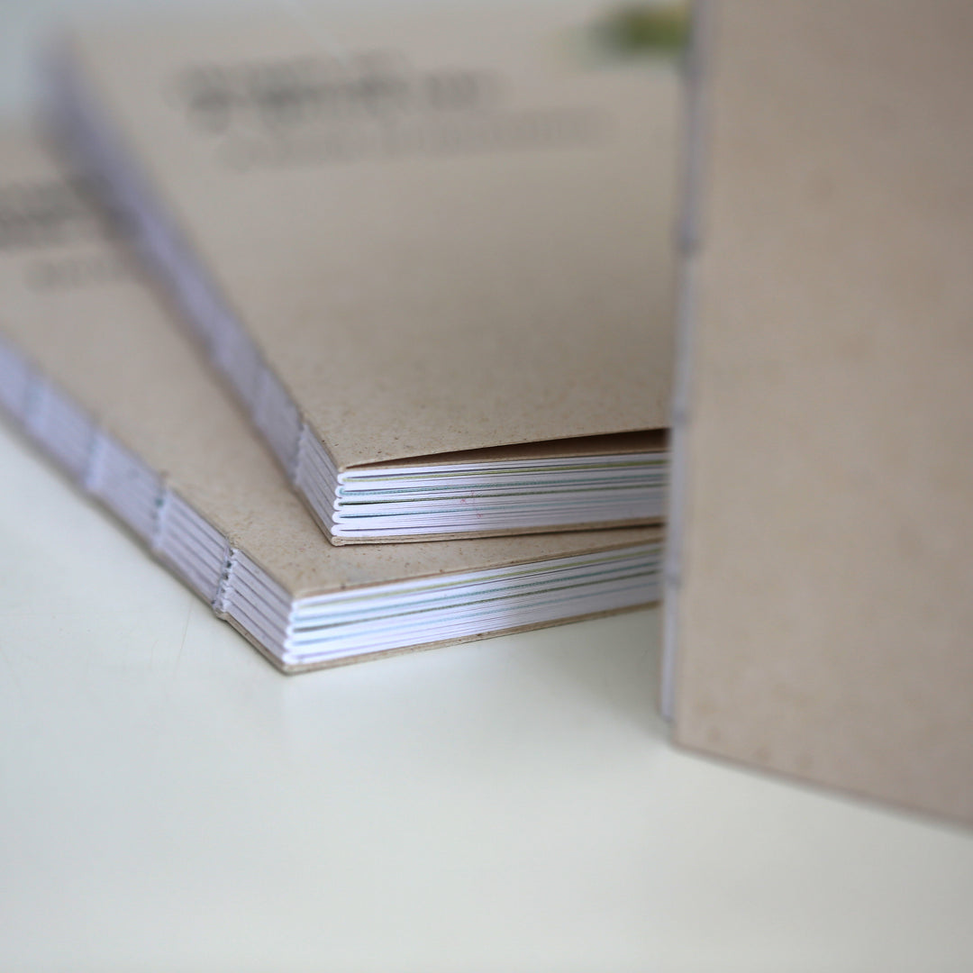 Stack of 'Ikigai or A Good Life' books with handcrafted binding, emphasizing their eco-friendly materials and minimalist design