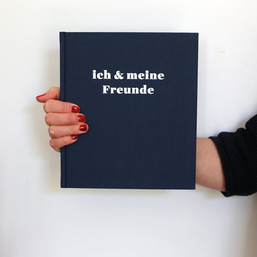 Book of Friendship in German for Adults. dark blue cover with silver colored hot foil embossing.