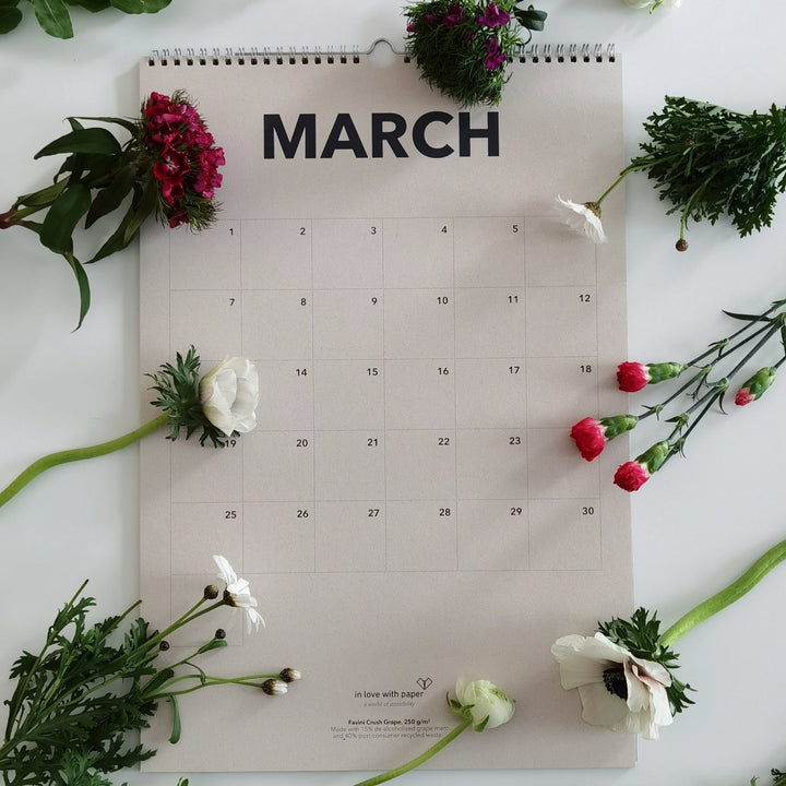 March page of the everlasting calendar surrounded by fresh flowers, creating a spring-inspired look.