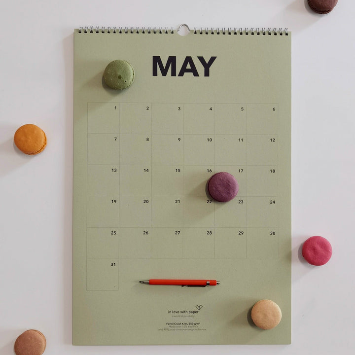 May page of the everlasting calendar with colorful macarons and a red pen for a playful touch.