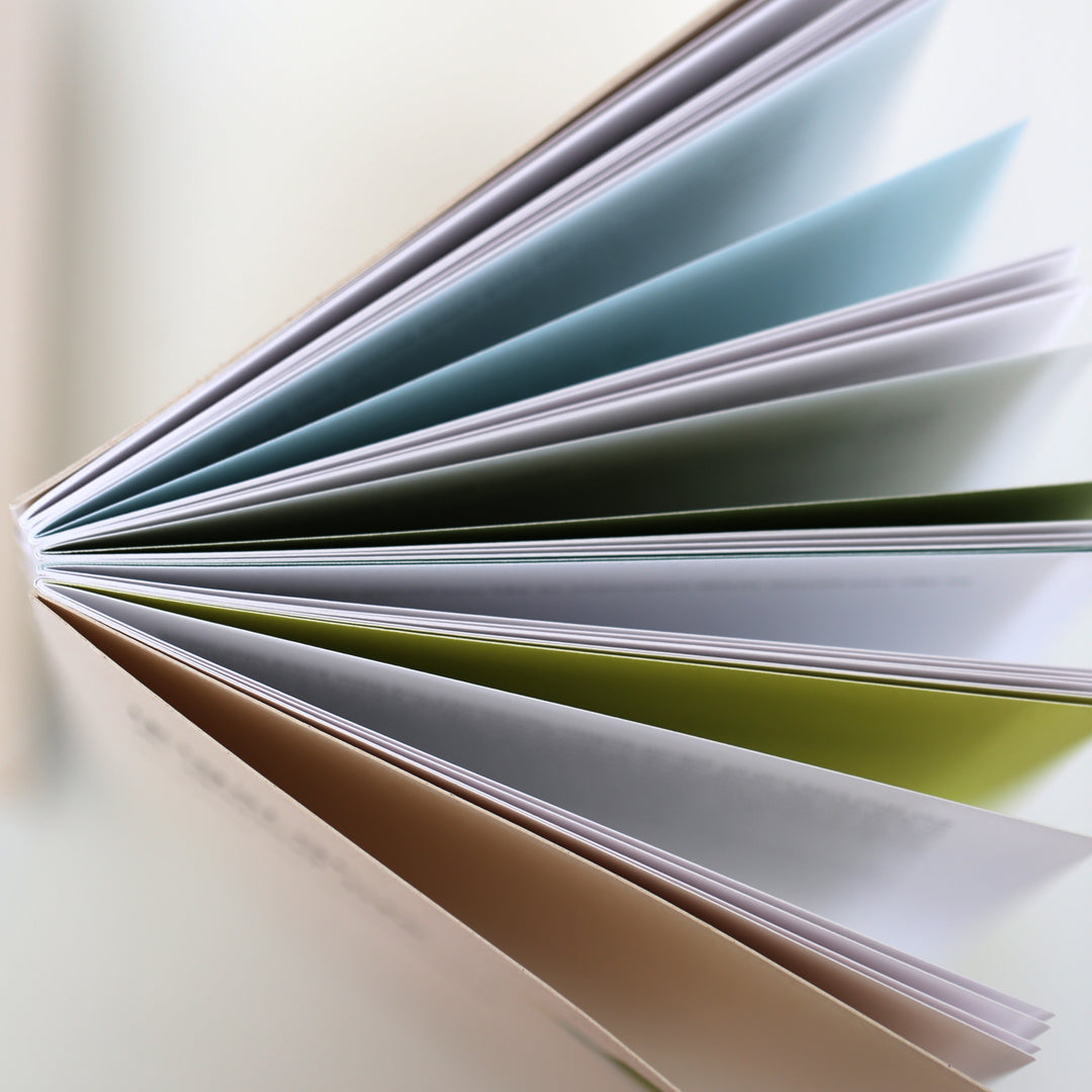 Farbige Seiten des Ikigai Buchs aufgefächert, zeigen die Vielfalt der Innenseiten.