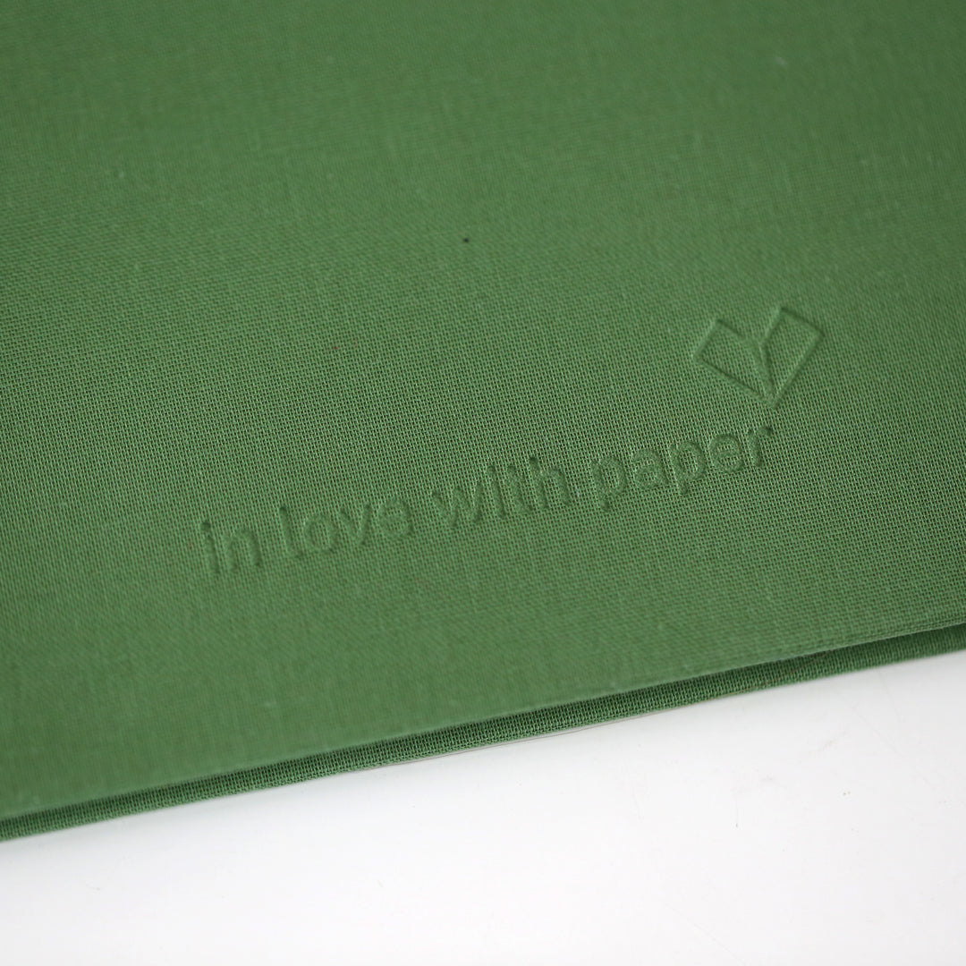 Green cover of friendship book with 'in love with paper' blind embossing logo.