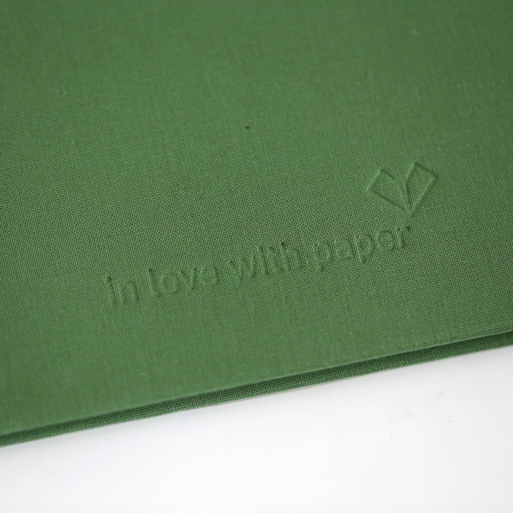 Green cover of friendship book with 'in love with paper' blind embossing logo.