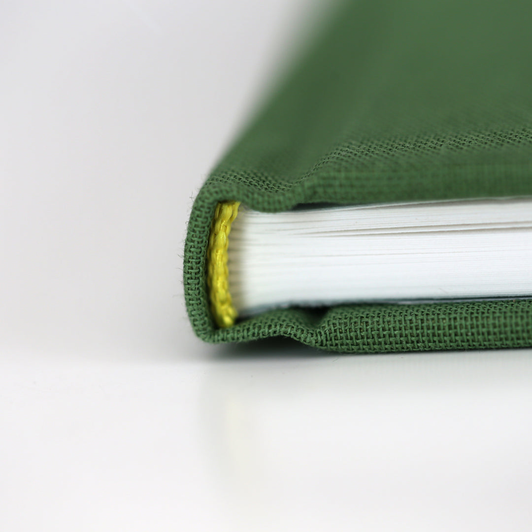 Green friendship book spine with yellow stitching detail.
