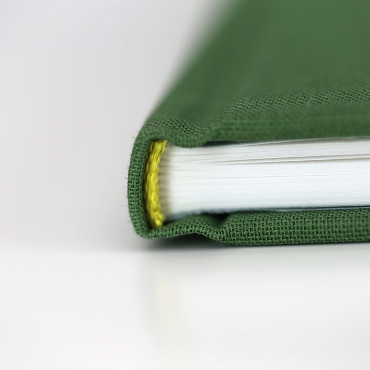 Green friendship book spine with yellow stitching detail.